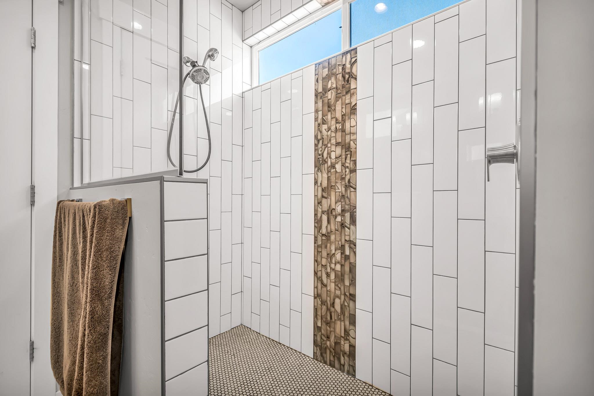 506 Grama Court Grand Junction, CO 81504 - Photo 17 of 28 a bathroom with a shower curtain and a window