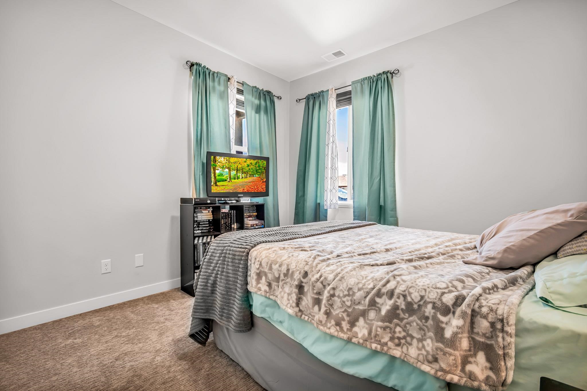 506 Grama Court Grand Junction, CO 81504 - Photo 20 of 28 a bedroom with a bed and a flat tv screen on a dresser