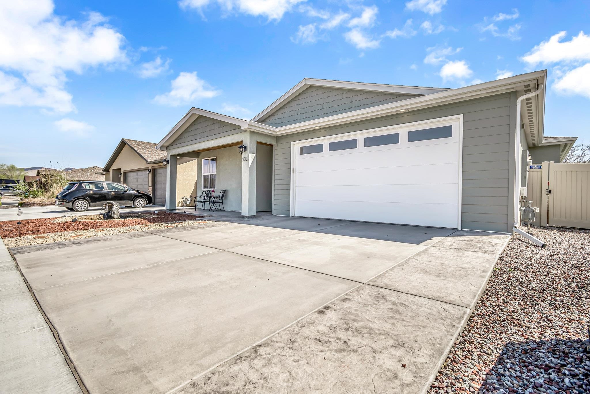 506 Grama Court Grand Junction, CO 81504 - Photo 3 of 28 a view of a white house with a outdoor space