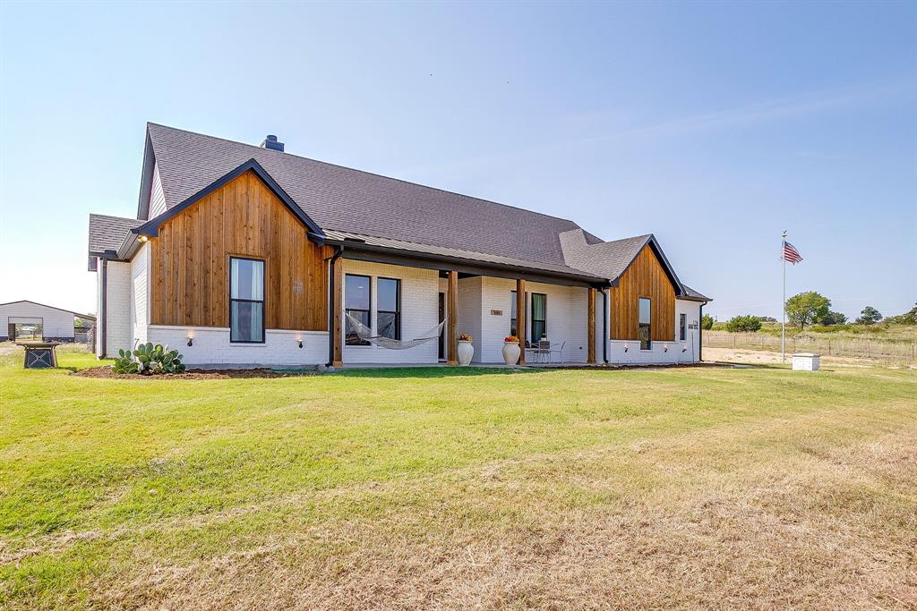 116 Aviara Ridge Road Poolville, TX 76487 - Photo 36 of 38 a front view of house with yard and ocean view