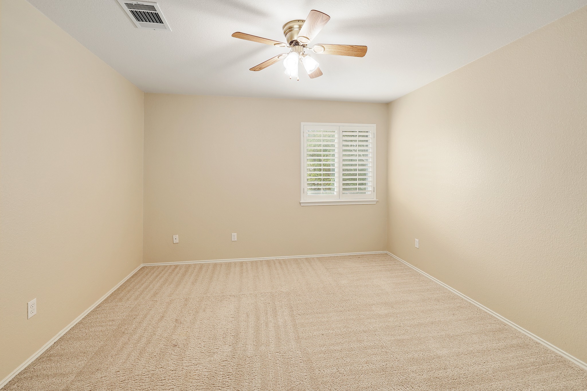 4615 Tello Path Austin, TX 78749 - Photo 23 of 31 Plush carpeting and plantation shutters highlight this versatile secondary bedroom space.
