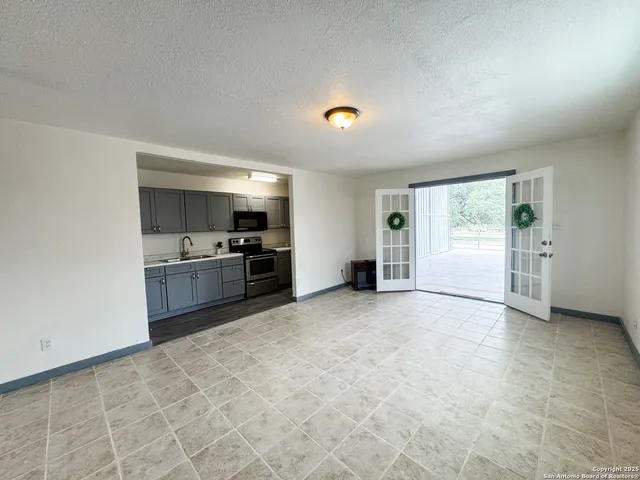 a view of a kitchen with a sink and a refrigerator
