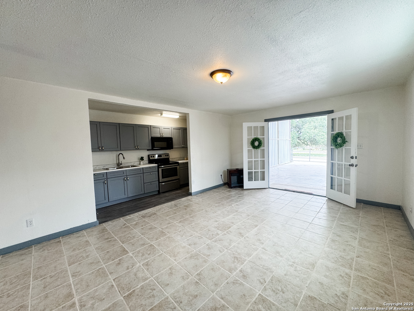 a view of a kitchen with a sink and a refrigerator