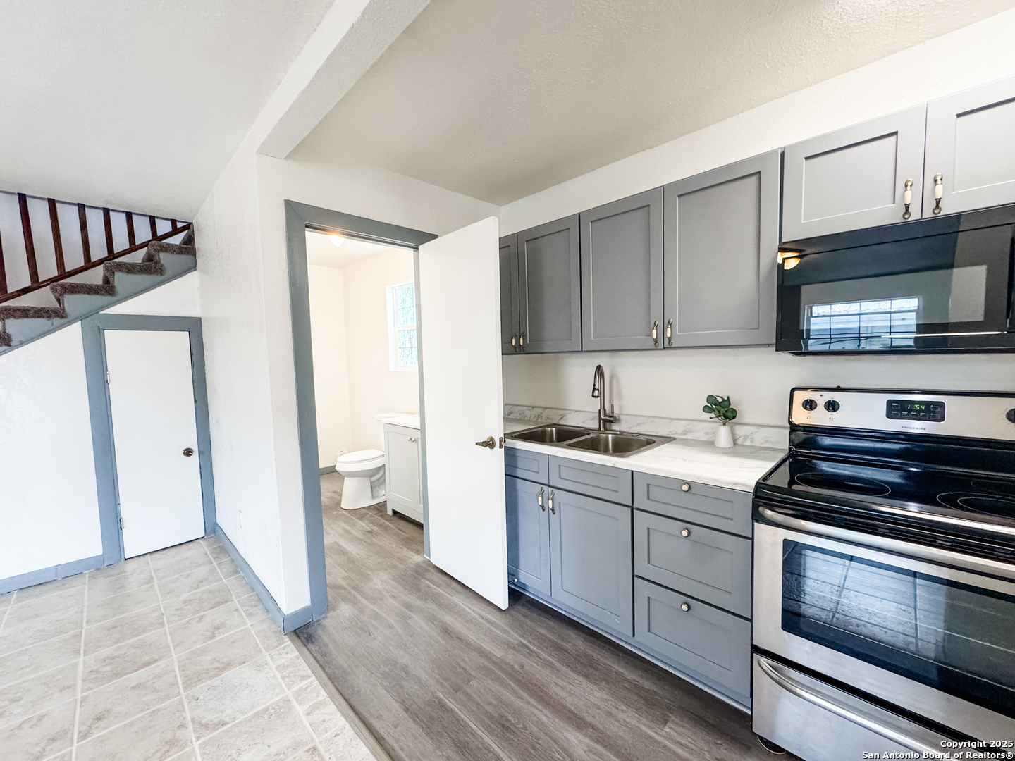 205 Plaza Navarra Road Brackettville, TX 78832 - Photo 11 of 21 a kitchen with stainless steel appliances a stove a sink and a microwave