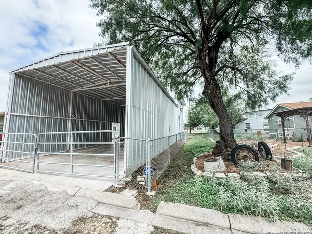 a backyard of a house with plants and trees