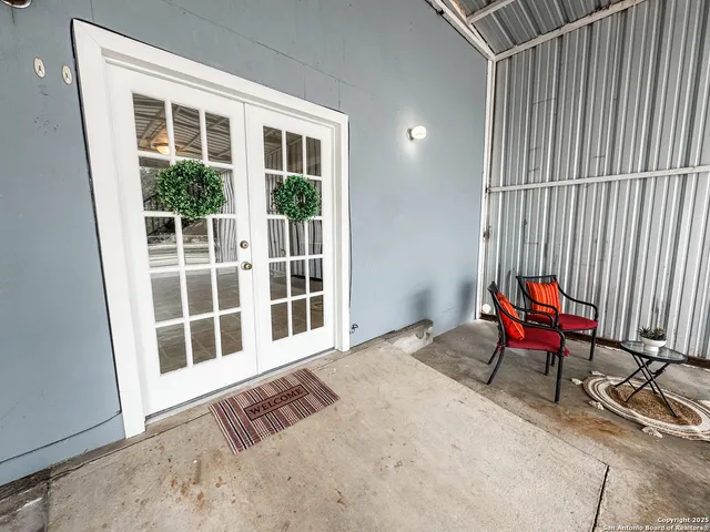 a living room with a rug floor and a window