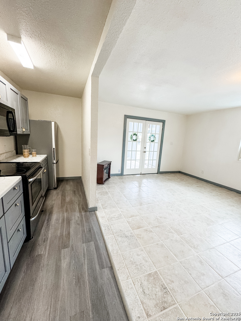 205 Plaza Navarra Road Brackettville, TX 78832 - Photo 9 of 21 a view of a kitchen with furniture and wooden floor