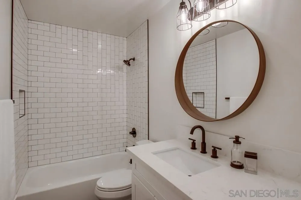 809 Colima Street La Jolla, CA 92037 - Photo 13 of 25 a bathroom with a sink a toilet and a mirror