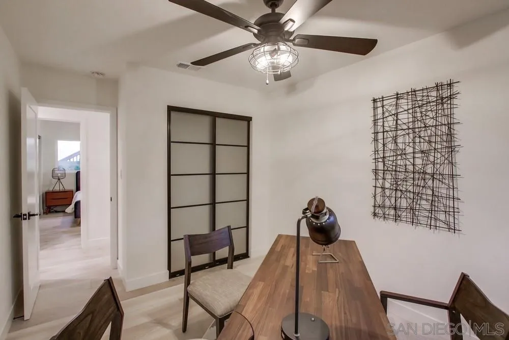 809 Colima Street La Jolla, CA 92037 - Photo 14 of 25 a bedroom with a bed and a chandelier