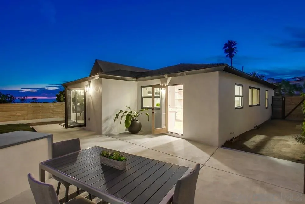809 Colima Street La Jolla, CA 92037 - Photo 22 of 25 a view of a house with a dining table and chairs with wooden floor