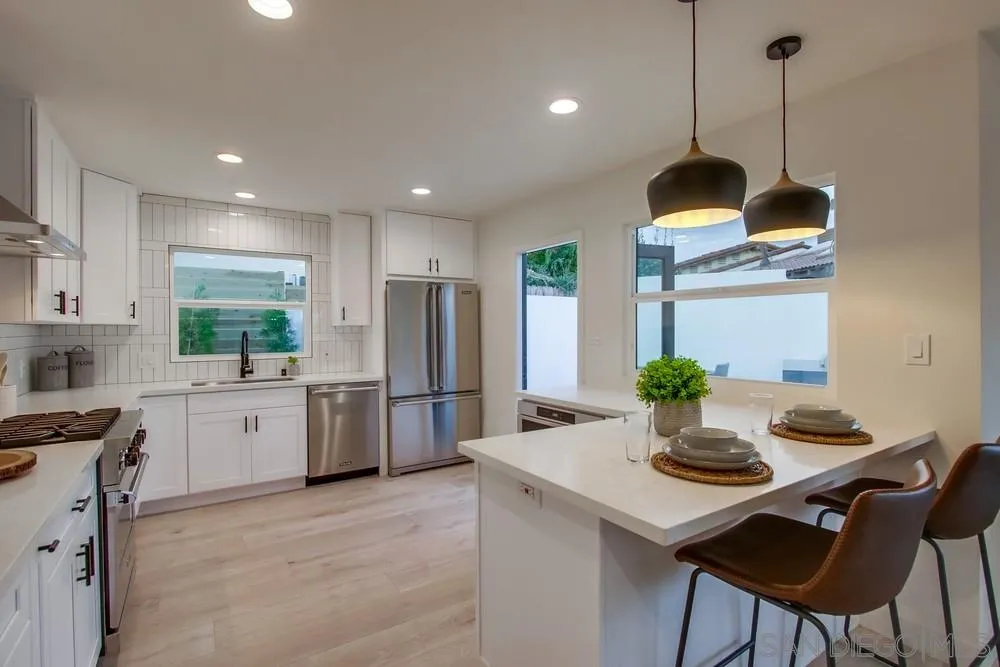 809 Colima Street La Jolla, CA 92037 - Photo 4 of 25 a kitchen with refrigerator and chairs