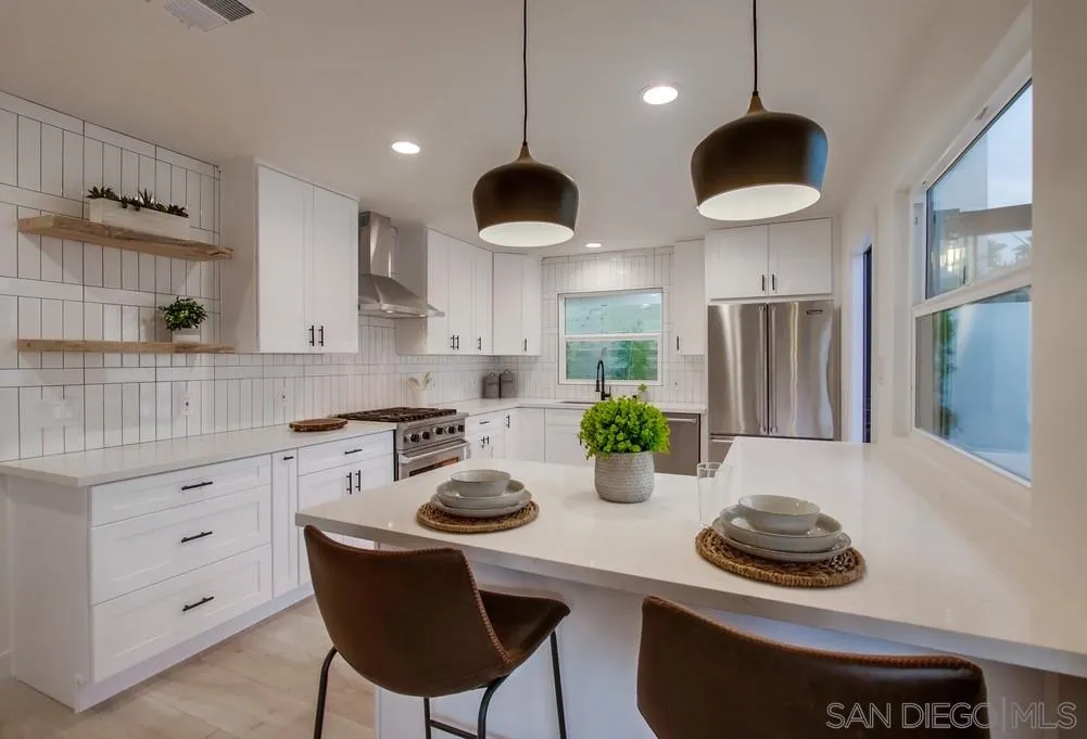 809 Colima Street La Jolla, CA 92037 - Photo 5 of 25 a kitchen with stainless steel appliances a stove a sink and a refrigerator