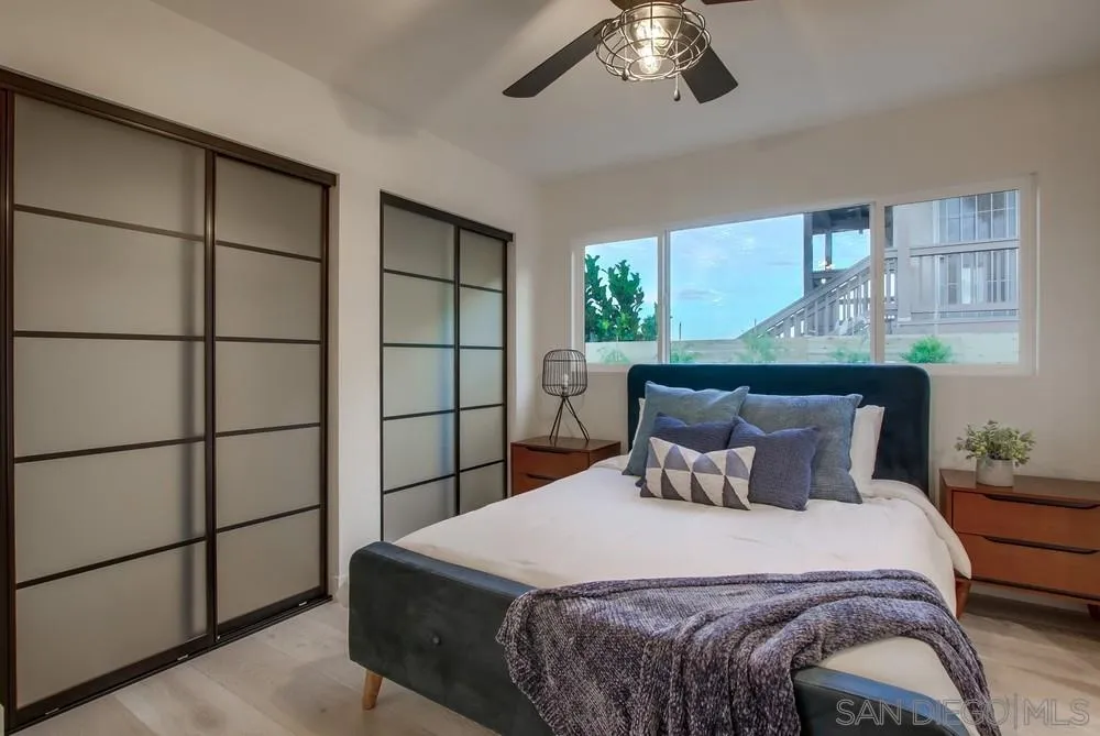 809 Colima Street La Jolla, CA 92037 - Photo 9 of 25 a bedroom with a bed and a window