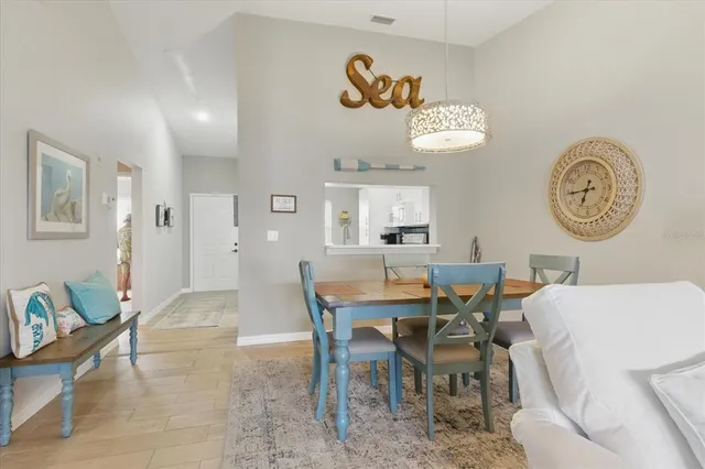a view of a dining area with furniture and a large window