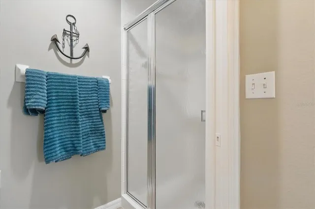 a bathroom with a shower and a mirror