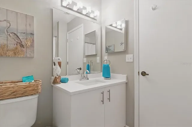 a bathroom with a granite countertop sink a mirror and shower