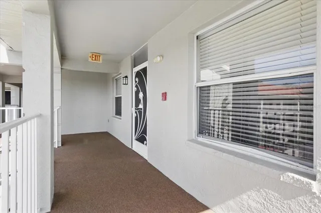 a view of a hallway to rooms