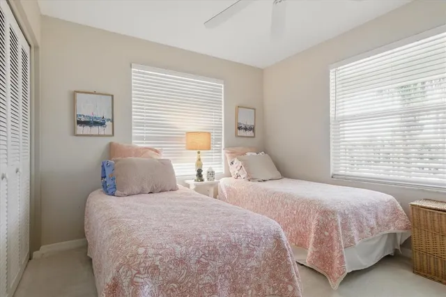 a bedroom with two beds and a window