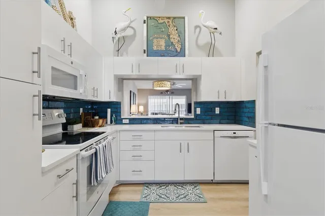 a kitchen with stainless steel appliances granite countertop a sink and cabinets
