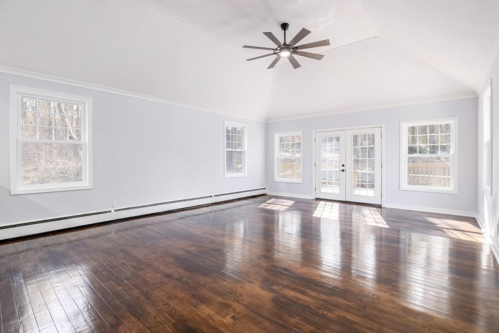 370 Thompson Road Webster, MA 01570 - Photo 16 of 42 a view of an empty room with wooden floor and a window