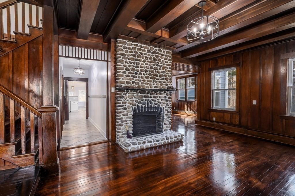 370 Thompson Road Webster, MA 01570 - Photo 26 of 42 a view of an empty room with wooden floor fire place and windows