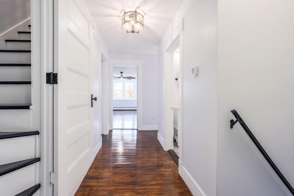 370 Thompson Road Webster, MA 01570 - Photo 30 of 42 a view of a hallway with wooden floor and staircase