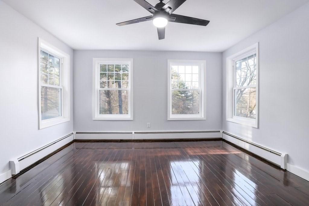 370 Thompson Road Webster, MA 01570 - Photo 36 of 42 a view of an empty room with wooden floor and a window