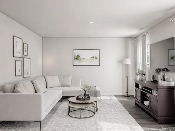 a living room with furniture a rug and a window