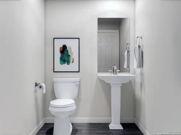 a bathroom with a toilet a sink and mirror