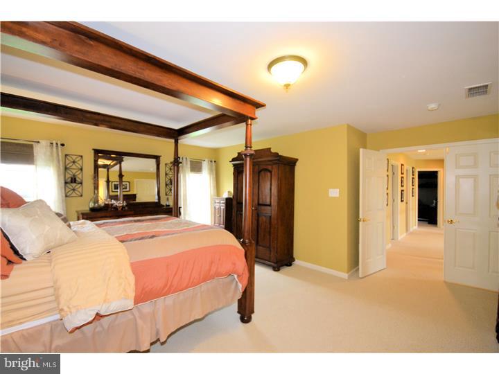 213 Barnhill Road Perkasie, PA 18944 - Photo 18 of 25 a bedroom with a bed and a large mirror on the dresser