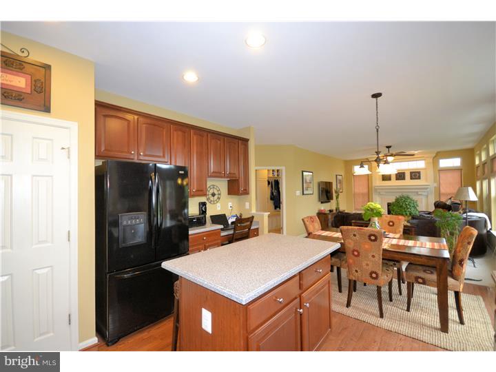 213 Barnhill Road Perkasie, PA 18944 - Photo 5 of 25 a kitchen with stainless steel appliances a dining table chairs and a refrigerator