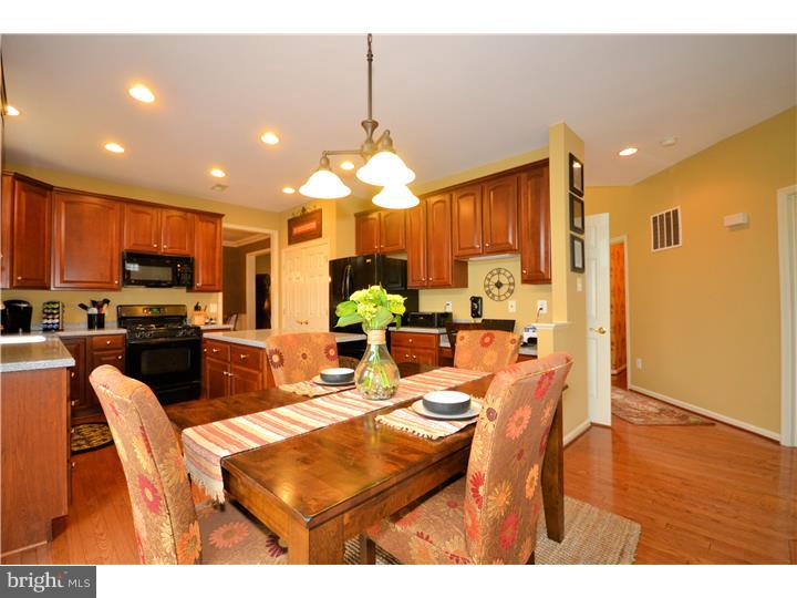 213 Barnhill Road Perkasie, PA 18944 - Photo 7 of 25 a kitchen with stainless steel appliances kitchen island granite countertop a refrigerator a stove a sink dishwasher with a dining table and chairs