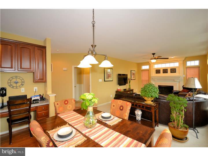 213 Barnhill Road Perkasie, PA 18944 - Photo 8 of 25 a living room with furniture a fireplace and a dining table with garden view