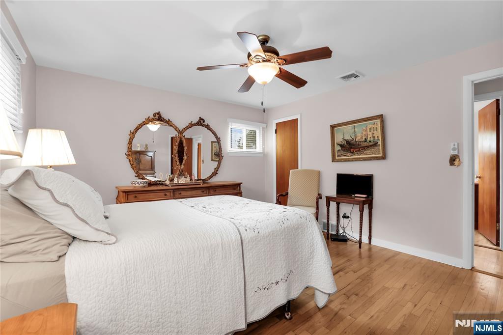 23 Ridge Court Cedar Grove, NJ 07009 - Photo 20 of 37 a bedroom with a bed and a chandelier