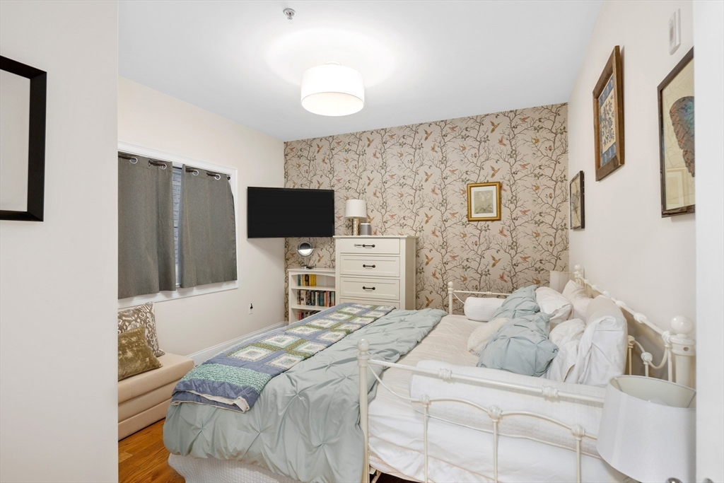 299 Sumner Street, Unit 1 Boston, MA 02128 - Photo 17 of 23 a bedroom with a bed and a flat screen tv