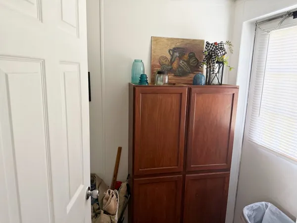 a view of a hallway with workspace and a window