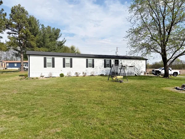 a swimming pool view with a garden and trees