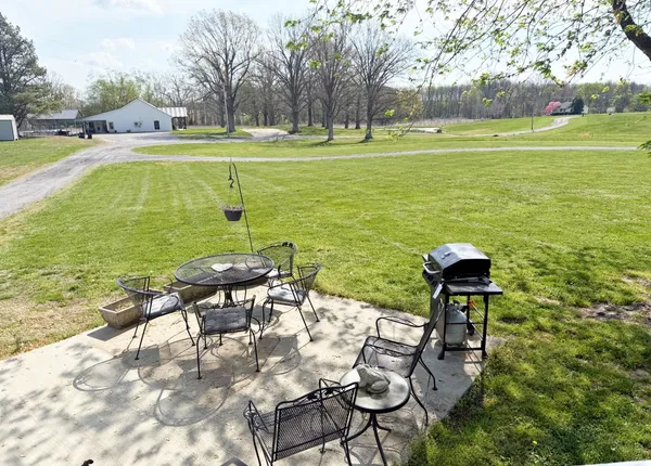 a view of a lake with a table and chairs
