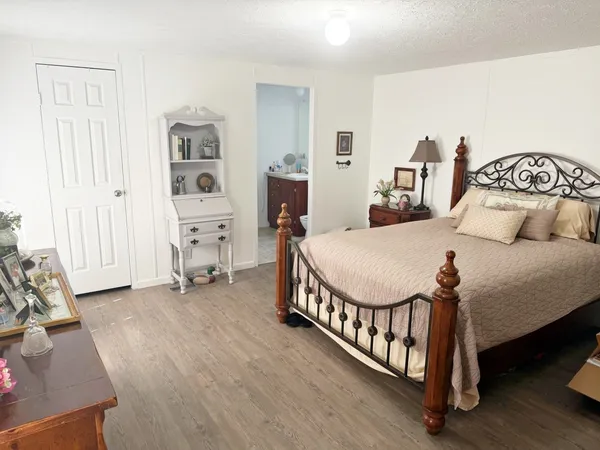 a bedroom with furniture and a window