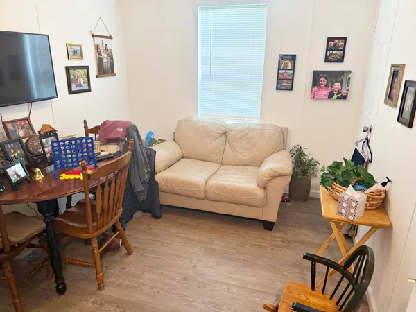 a living room with furniture and wooden floor