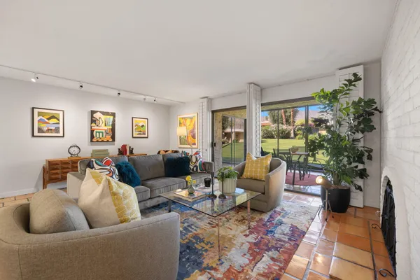 a living room with furniture potted plant and a window