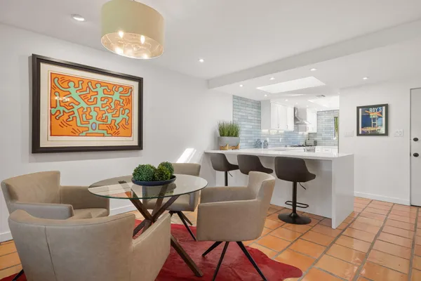 a living room with furniture and a dining table