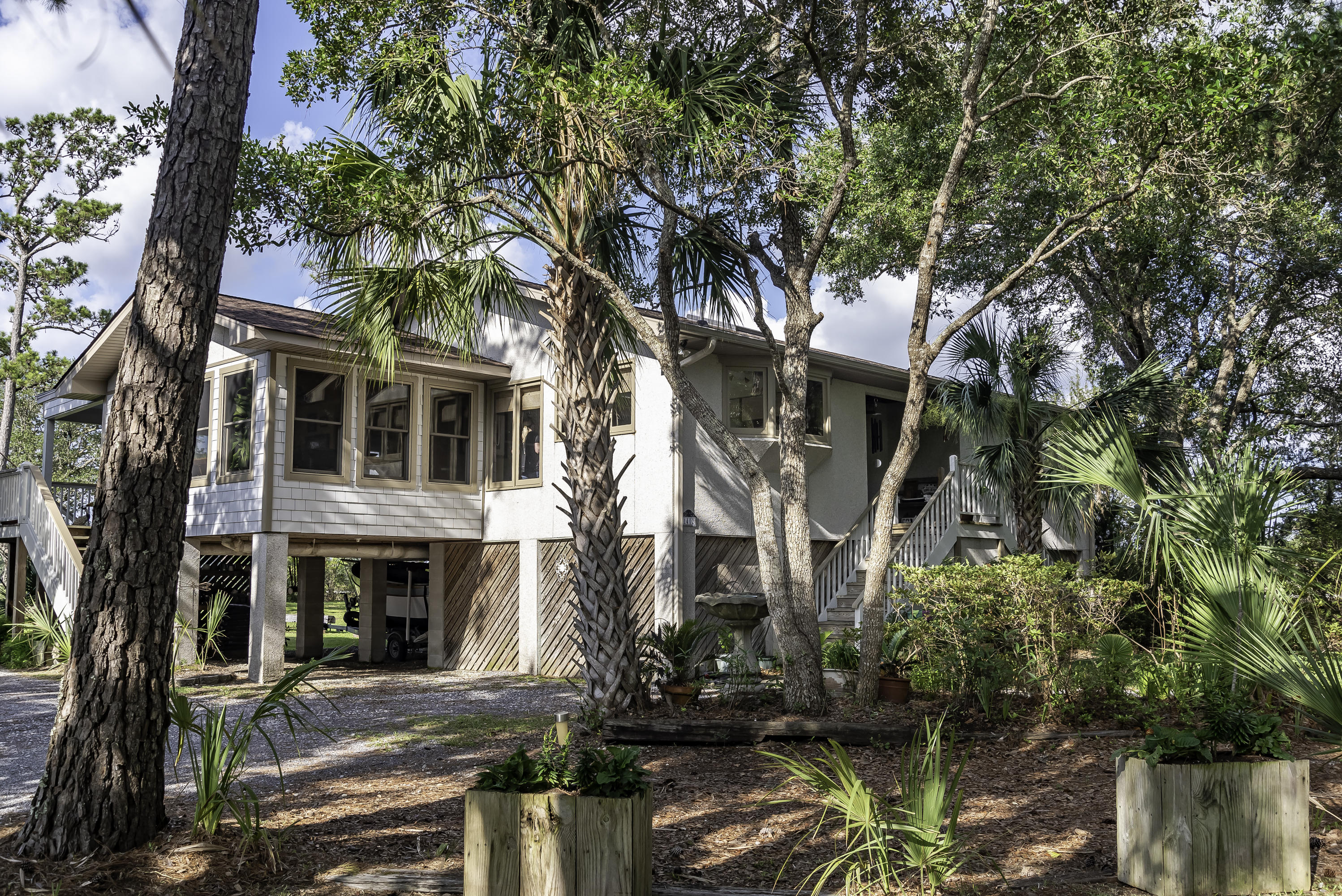 1402 Marshwind Island Road Awendaw, SC 29429 - Photo 2 of 33 Lush vegetation surrounds this home