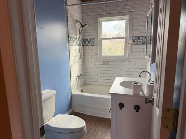 a bathroom with a sink a toilet and shower
