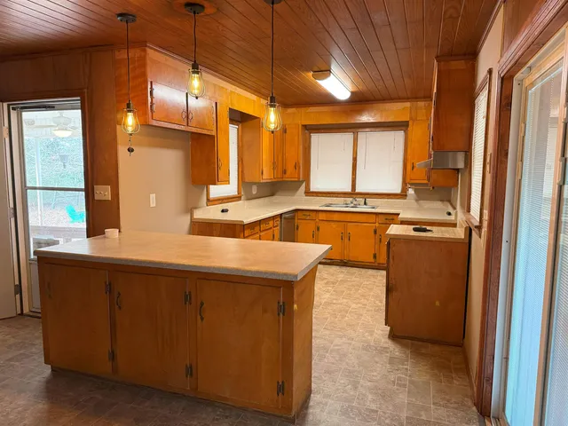 a kitchen with stainless steel appliances granite countertop a sink and a refrigerator