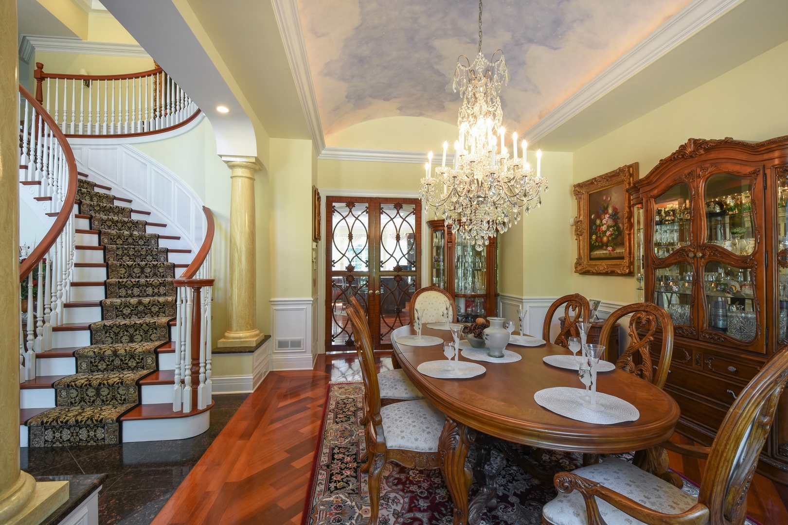 595 Plum Tree Road Barrington Hills, IL 60010 - Photo 11 of 46 a dining room with wooden floor a chandelier a wooden table and chairs