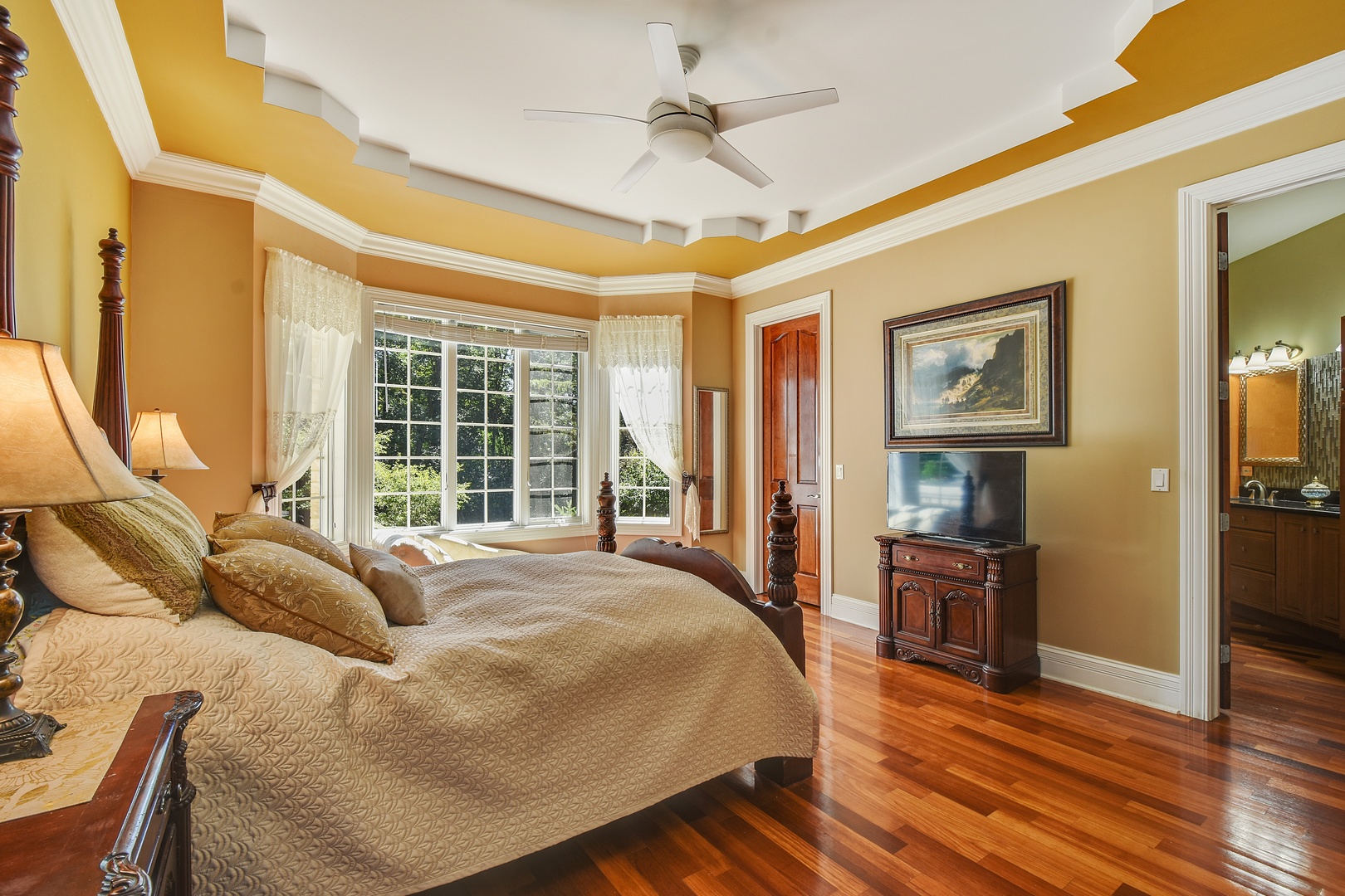 595 Plum Tree Road Barrington Hills, IL 60010 - Photo 25 of 46 a spacious bedroom with a bed and wooden floor