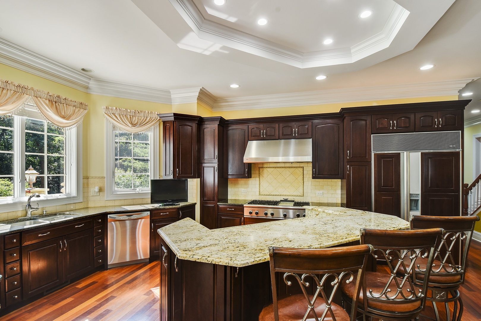 595 Plum Tree Road Barrington Hills, IL 60010 - Photo 8 of 46 a kitchen with stainless steel appliances granite countertop a stove a sink and a microwave