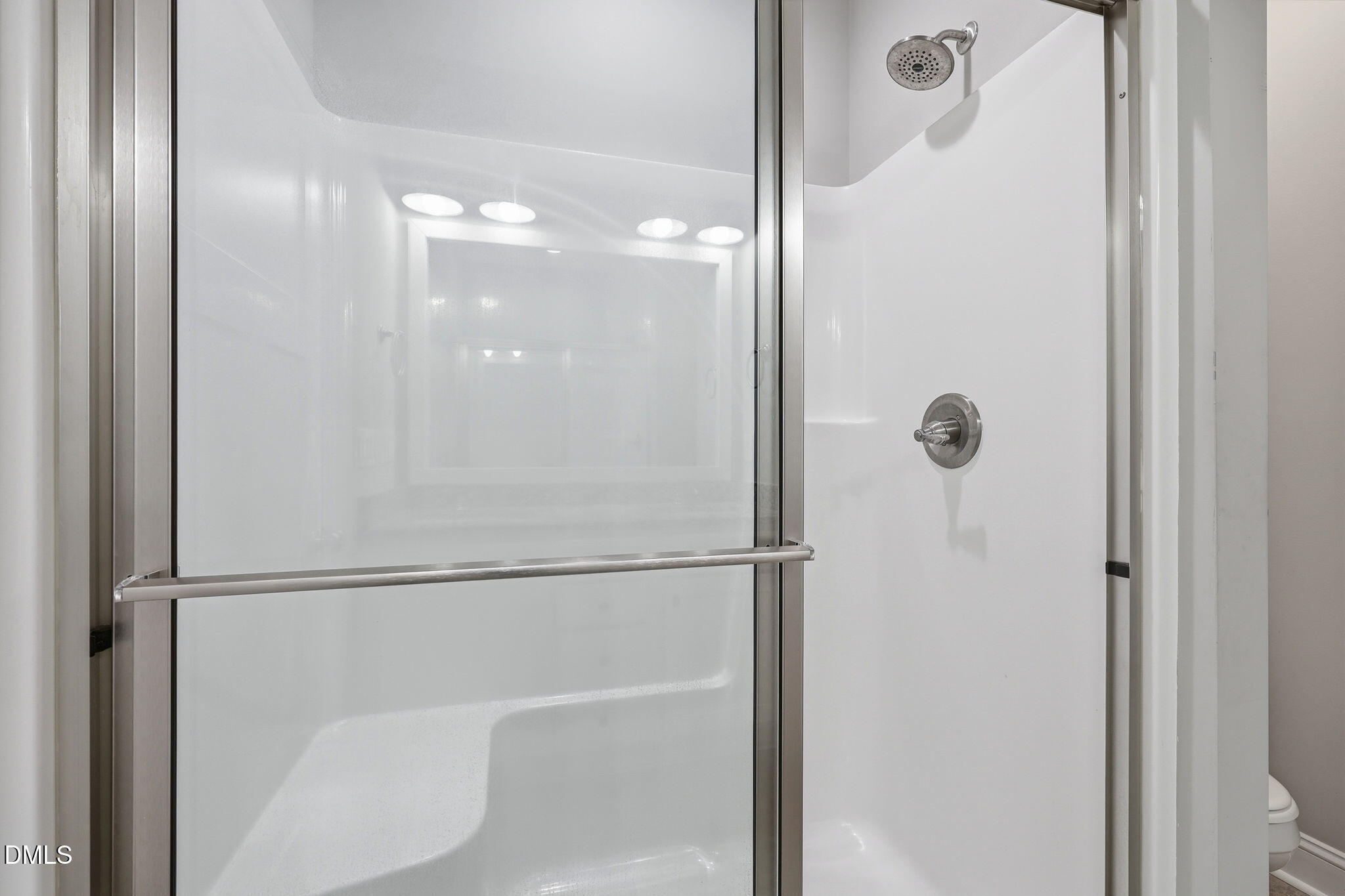 709 South Pollock Street Selma, NC 27576 - Photo 22 of 30 a bathroom with a glass shower door