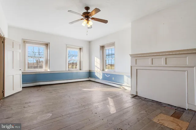 wooden floor in an empty room with a window